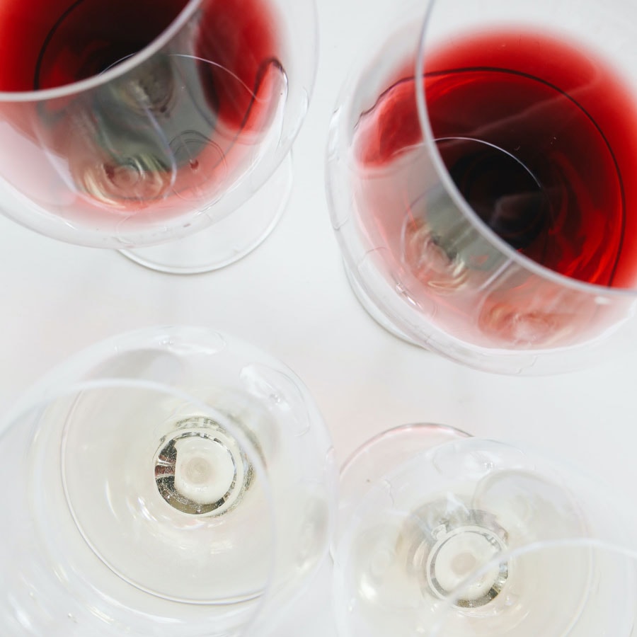 Top view of red and white wine glasses, showcasing winemaking services and beverage development