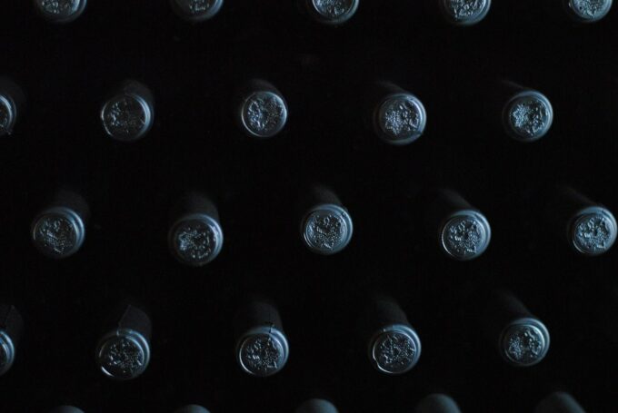 The tops of private label wine bottles with black lids
