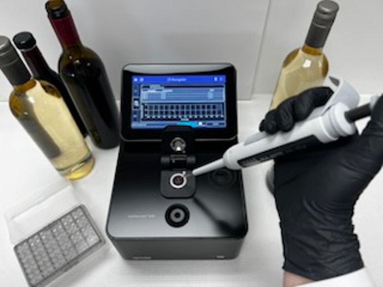 Laboratory technician using Implen NanoPhotometer NP80 for wine quality control and fermentation analysis