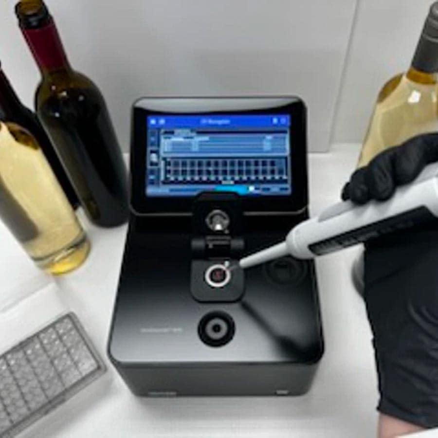 Spectroscopy lab equipment analyzing wine, used in beverage production and quality control