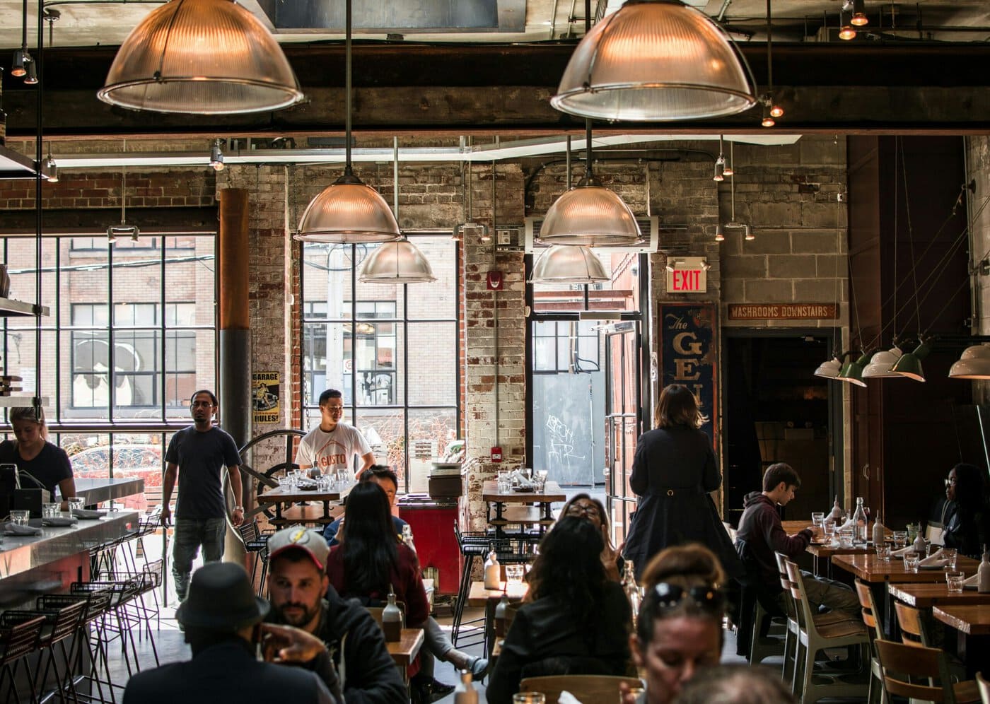 Lots of people sat at tables at a busy restaurant